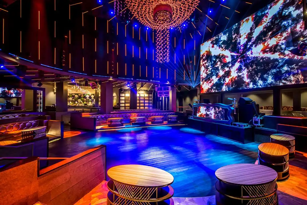 bartenders serving drinks in busy nightclub