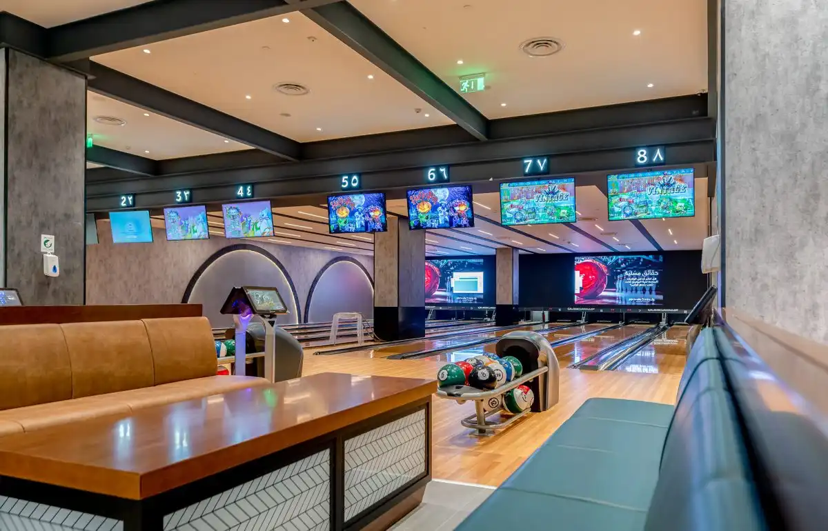 bowling alley staff assisting customers near lanes