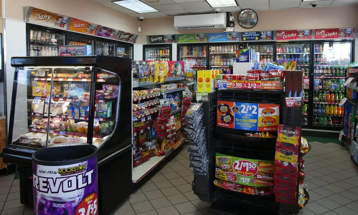 convenience store employees assisting customers at checkout
