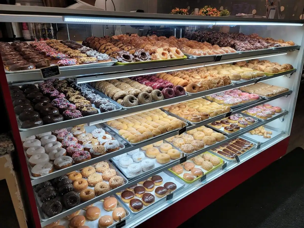 donut shop employees preparing fresh donuts