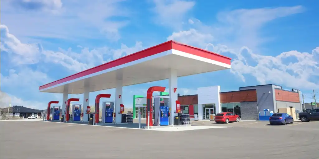 gas station staff assisting customers at fuel pumps
