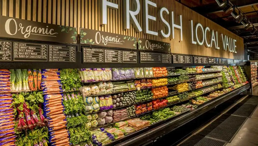 grocery store employees stocking shelves