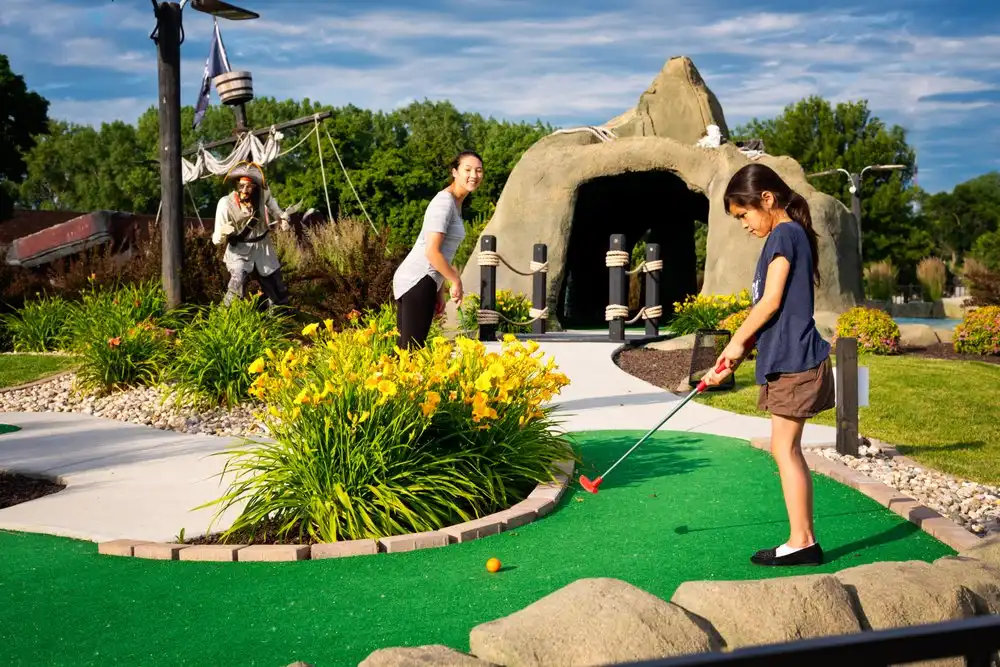 mini golf course staff assisting players