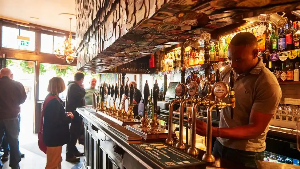 pub staff serving drinks and meals