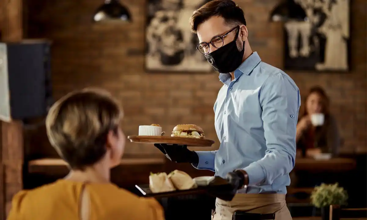 restaurant servers assisting guests in dining room