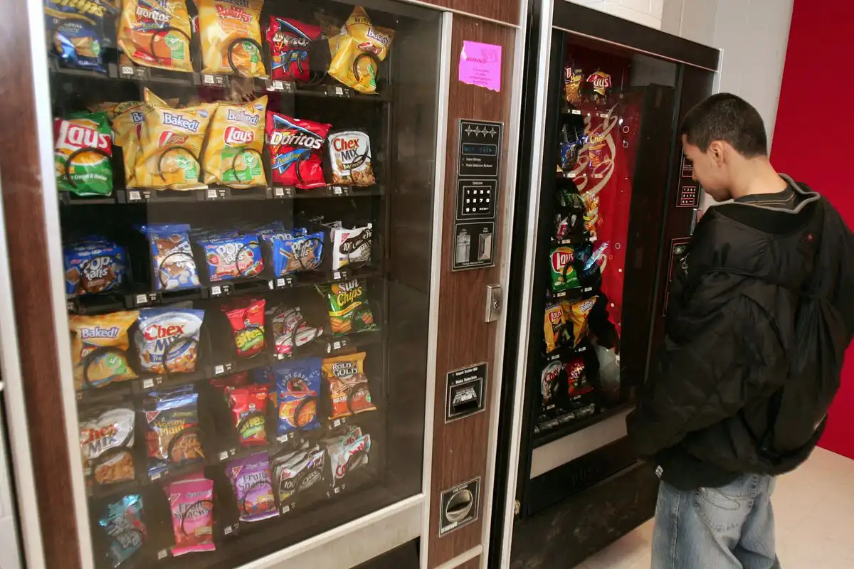 technician servicing commercial vending machines